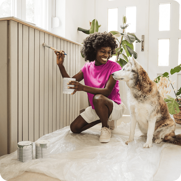 A person painting with their dog